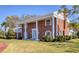 Stately brick home with grand columns and a manicured lawn offering curb appeal at 3215 Pine Valley Dr, Sarasota, FL 34239