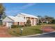 Traditional brick home with white columns, well-kept lawn, circular driveway, and attached garage at 3215 Pine Valley Dr, Sarasota, FL 34239