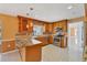 Spacious kitchen featuring stainless steel appliances, tile floors, and granite countertops at 3215 Pine Valley Dr, Sarasota, FL 34239