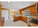 Well-lit kitchen featuring wood cabinets, granite countertops, and stainless steel appliances at 3215 Pine Valley Dr, Sarasota, FL 34239