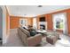 Inviting living room with fireplace, neutral sofa, bright windows, and elegant decor at 3215 Pine Valley Dr, Sarasota, FL 34239