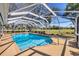Enjoy this sparkling in-ground pool with a screened enclosure and a spacious patio at 3215 Pine Valley Dr, Sarasota, FL 34239