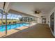 Relax by this sparkling screened-in pool and lanai with views of the outdoor scenery at 3215 Pine Valley Dr, Sarasota, FL 34239