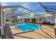 Enclosed in-ground pool with a screen enclosure and concrete deck, perfect for relaxation and entertainment at 3215 Pine Valley Dr, Sarasota, FL 34239