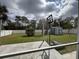 Backyard featuring an enclosed shed and a basketball hoop with lots of lawn space at 3650 S Sumter Blvd, North Port, FL 34287