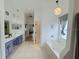 Spacious primary bathroom with double vanity, soaking tub, and natural light at 3650 S Sumter Blvd, North Port, FL 34287