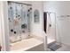 Well-lit bathroom with a separate tub and walk-in shower featuring modern fixtures at 3650 S Sumter Blvd, North Port, FL 34287