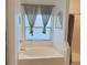 Bright bathroom with a tub, a window, and a separate shower featuring modern fixtures at 3650 S Sumter Blvd, North Port, FL 34287