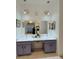 Bathroom vanity with double sinks, marble countertops, and stylish lighting fixtures at 3650 S Sumter Blvd, North Port, FL 34287