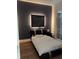 Modern bedroom with a dark accent wall, a platform bed with ambient lighting, and contemporary style at 3650 S Sumter Blvd, North Port, FL 34287