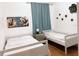 Bright bedroom with two twin beds, modern wall art, and stylish blue curtains at 3650 S Sumter Blvd, North Port, FL 34287