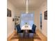 Bright dining room features a chandelier and a sleek, modern table with blue chairs at 3650 S Sumter Blvd, North Port, FL 34287