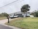 Charming single-story home featuring a well-maintained lawn, two palm trees, and a driveway with a parked car at 3650 S Sumter Blvd, North Port, FL 34287