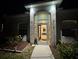 Inviting front entrance with glass door and sidelights, offering a glimpse of the well-lit interior at 3650 S Sumter Blvd, North Port, FL 34287