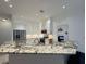 Modern kitchen featuring marble countertops, stainless steel appliances, and custom cabinetry at 3650 S Sumter Blvd, North Port, FL 34287