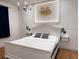 Elegantly decorated main bedroom with a chandelier and a modern white bed frame at 3650 S Sumter Blvd, North Port, FL 34287