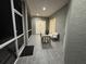 Enclosed patio featuring tiled floors, comfortable seating, and natural light, creating a relaxing outdoor space at 3650 S Sumter Blvd, North Port, FL 34287