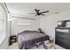 Bedroom featuring neutral colors, a ceiling fan, and plenty of natural light from two windows at 3721 Delta St # 93, Sarasota, FL 34232