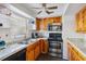 Traditional kitchen with wood cabinets, stainless steel appliances, granite countertops and a ceiling fan at 3721 Delta St # 93, Sarasota, FL 34232