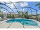 Backyard screened in pool with tropical landscaping, lounge chairs, and a relaxing atmosphere at 3815 75Th E Ln, Palmetto, FL 34221