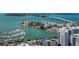 Breathtaking aerial view of waterfront condos, a marina filled with boats, and a bridge in the background at 3933 Glen Oaks Manor Dr, Sarasota, FL 34232