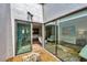 Sun-filled atrium viewable from the living room provides a tranquil retreat at 3933 Glen Oaks Manor Dr, Sarasota, FL 34232