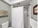 Full bathroom with white shower curtain and tub-shower combination at 3933 Glen Oaks Manor Dr, Sarasota, FL 34232