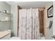 Bathroom featuring updated fixtures, shower-tub combination, and white shower curtain at 3933 Glen Oaks Manor Dr, Sarasota, FL 34232
