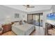 Bedroom with sliding glass door access to the outdoor brick patio and en-suite bath at 3933 Glen Oaks Manor Dr, Sarasota, FL 34232