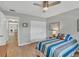 Bright bedroom with wood floors, a ceiling fan, and access to an en-suite bath at 3933 Glen Oaks Manor Dr, Sarasota, FL 34232