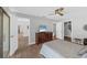 Bedroom with ceiling fan, wood-look tile flooring, and a dresser with a television at 3933 Glen Oaks Manor Dr, Sarasota, FL 34232