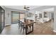 Dining room has hardwood floors, a ceiling fan, sliding glass door, and view to the kitchen at 3933 Glen Oaks Manor Dr, Sarasota, FL 34232