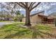 A tan single-story home shows a meticulously kept lawn and landscaping with mature trees at 3933 Glen Oaks Manor Dr, Sarasota, FL 34232