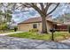 Beautiful home showcasing a tile roof, garage, and lush landscaping in a serene setting at 3933 Glen Oaks Manor Dr, Sarasota, FL 34232