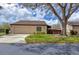 Charming home featuring a tile roof, well-manicured lawn, and a two-car garage at 3933 Glen Oaks Manor Dr, Sarasota, FL 34232