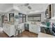 Bright kitchen with modern appliances, white cabinetry, and a window overlooking the backyard at 3933 Glen Oaks Manor Dr, Sarasota, FL 34232