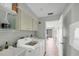 Bright laundry room featuring white washer and dryer, storage cabinets, and convenient sink at 3933 Glen Oaks Manor Dr, Sarasota, FL 34232