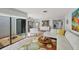 Bright living room with a unique rug, a view of the courtyard, and an open layout into the kitchen at 3933 Glen Oaks Manor Dr, Sarasota, FL 34232