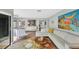 Bright living space featuring wood floors, white leather sectional, and colorful, vibrant artwork at 3933 Glen Oaks Manor Dr, Sarasota, FL 34232