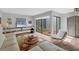Cozy living room with fireplace, comfortable seating and a view into a private courtyard at 3933 Glen Oaks Manor Dr, Sarasota, FL 34232
