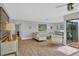 Bright living room with tile floors, contemporary furniture and sliding glass doors to the outside at 3933 Glen Oaks Manor Dr, Sarasota, FL 34232