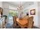 Inviting dining room with pool views, a chandelier, and a seamless transition to outdoor living for relaxed entertaining at 4108 Via Mirada, Sarasota, FL 34238