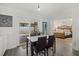 Bright dining area with a modern table and chairs, and a sliding glass door to the backyard at 4464 Gallup Ave, Sarasota, FL 34233