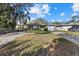 Lovely single-story home featuring a well-maintained lawn, lush landscaping, and an attached garage at 4464 Gallup Ave, Sarasota, FL 34233