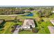 Expansive aerial view showcasing the property's pool, pond, lush landscaping, and serene surroundings at 4772 Vasca Dr, Sarasota, FL 34240