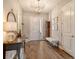 Elegant entryway featuring wood floors, chandelier, console table, and a vintage grandfather clock at 4772 Vasca Dr, Sarasota, FL 34240