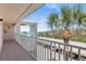 Balcony view of tropical trees, covered parking, and the ocean at 4835 Gulf Of Mexico Dr # 302B, Longboat Key, FL 34228