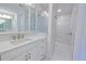 Bright bathroom featuring quartz countertops, custom cabinets and a frameless glass shower at 501 Tamiami N Trl # 601, Venice, FL 34285