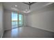 Clean bedroom featuring a ceiling fan, recessed lighting, and sliding glass doors to a balcony with water views at 501 Tamiami N Trl # 601, Venice, FL 34285