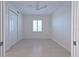 Bright bedroom with a ceiling fan, light gray flooring and plantation shutters at 501 Tamiami N Trl # 601, Venice, FL 34285